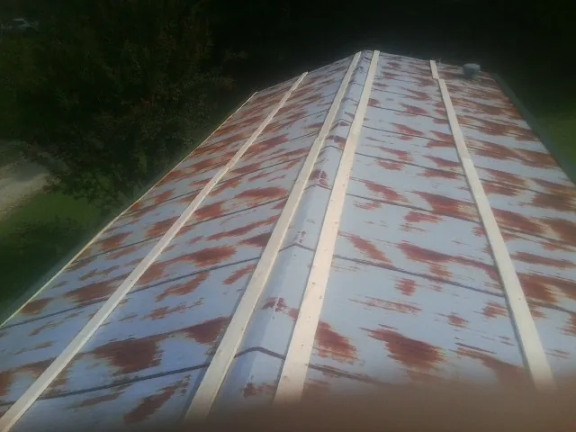 Rusted metal roof panels with new wood purlins before replacement — Storm Damage Roof Repair in Longford by Roofing Brothers